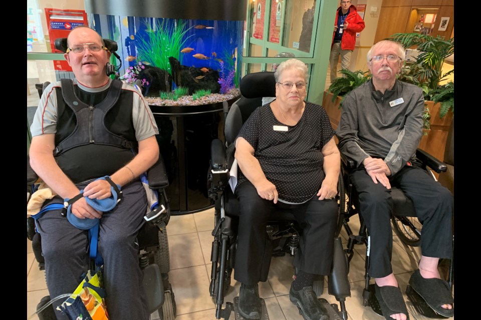 Newmarket Health Centre residents Michael Welgan (from left), Sharron Cooke and Arthur Holliday at yesterday's announcement of a provincial grant for regional seniors programs. Debora Kelly/NewmarketToday