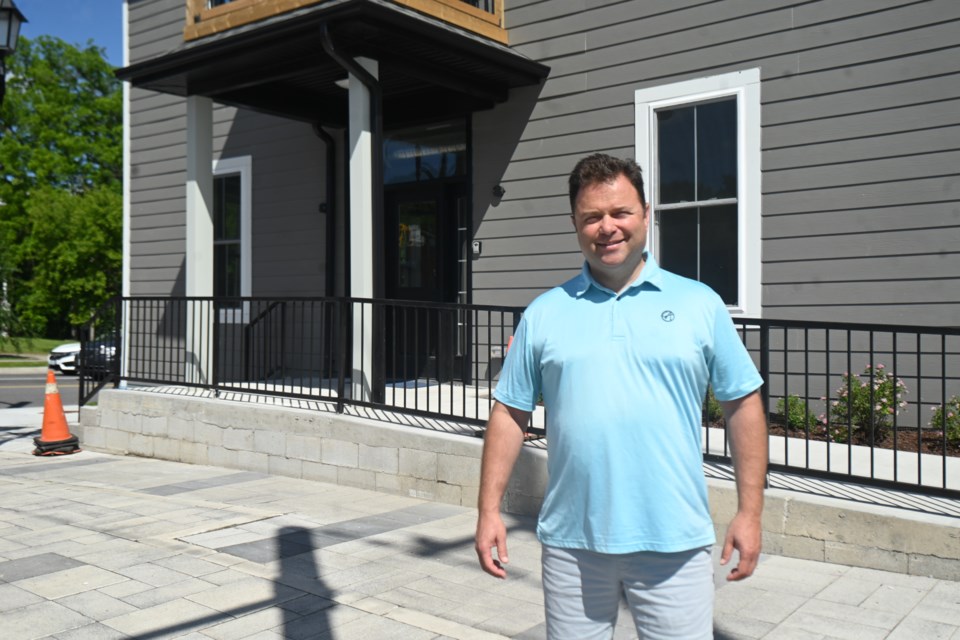 Dean Artenosi of Arten Development Group stands outside the nearly complete construction project at the former Union Hotel site on Davis at Main in Newmarket.