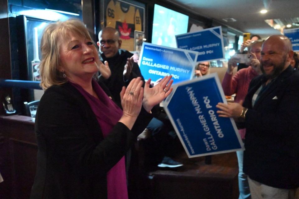 Conservative Dawn Gallagher Murphy arrives at her victory party in Aurora to cheering supporters.