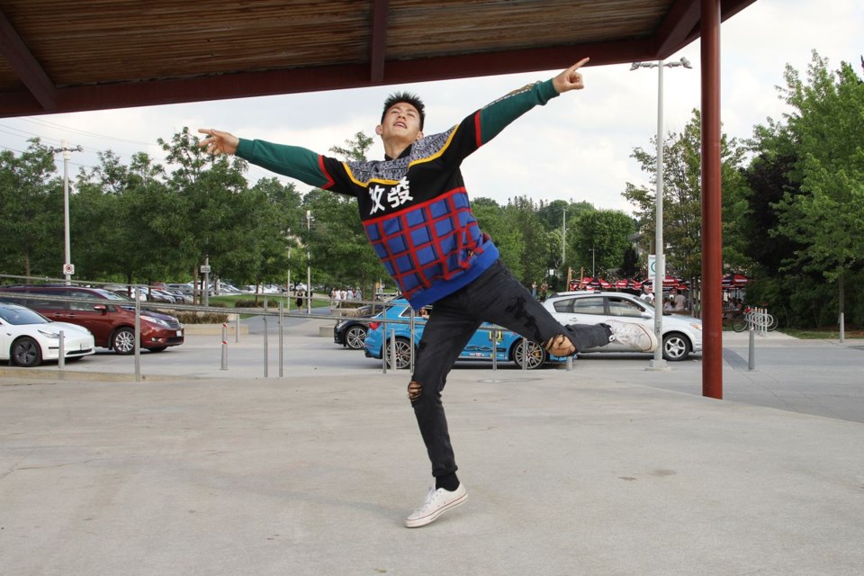 Caleb literally stops traffic while he breakdances on the stage at Riverwalk Commons. 