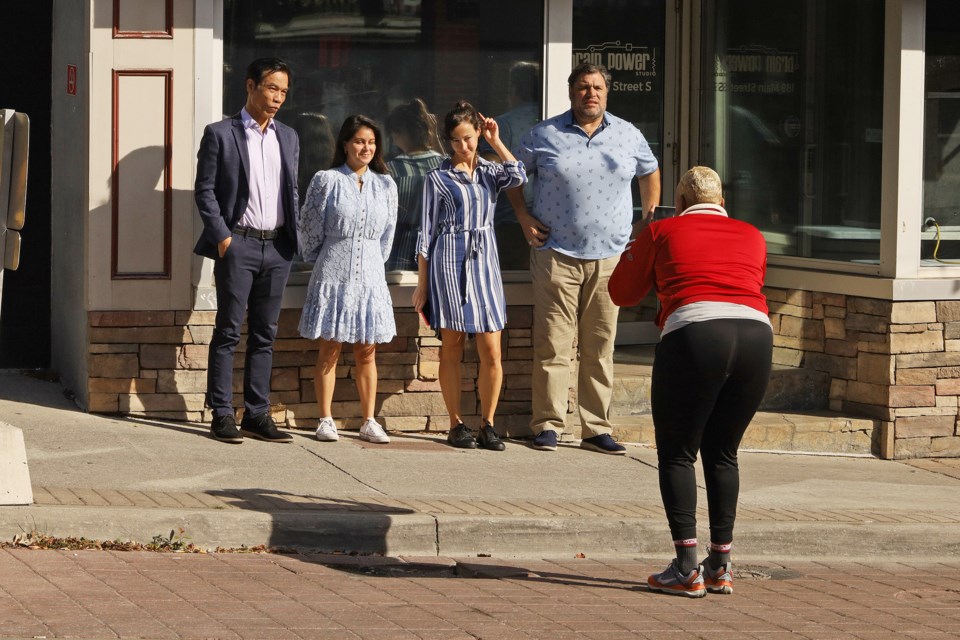 Main Street Newmarket became a film set this week for the Brain  Power Studio television movie Hearts of Robin Lane. Are these the actors? They pose outside the Brain Power office for a photo of a photo.