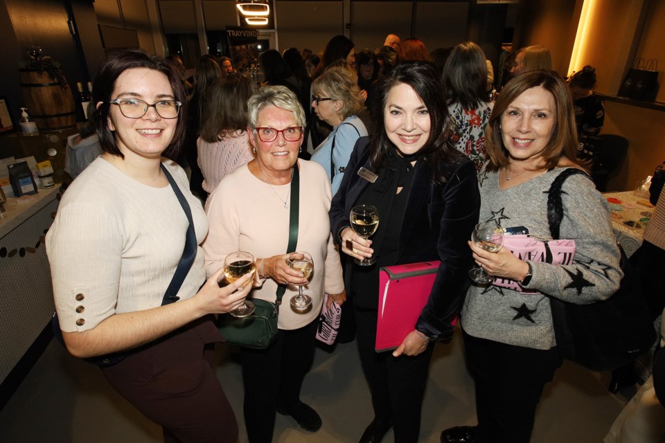 Melanie Osman, Jane Hinder and Arlyn Rathke join Southlake Foundation president and CEO Jennifer Ritter (holding binder), MC of the 14th annual NewRoads Girls Night Out in support of Girls Inc. last night at NewRoads Performing Arts Centre in Newmarket.