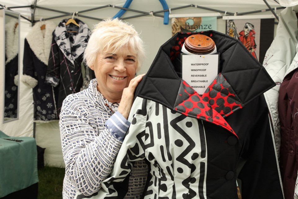 Linda Marsden displays the beautiful and practical coats that are waterproof, breathable, and washable, at the Newmarket Artisans Festival at Fairy Lake on the weekend.  Greg KIng for NewmarketToday