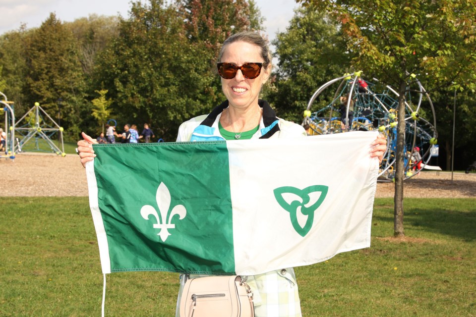 Retired school teacher Anita Laprairie holds a Franco-Ontarian flag at Newmarket's flag-raising ceremony Sept. 25 at Fairy Lake Park.  Greg King for NewmarketToday