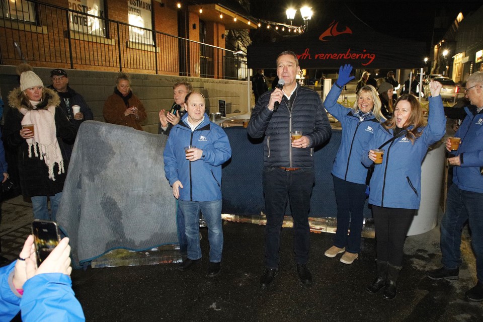 Councillors Christina Bisanz and Kelly Broome cheer as Mayor John Taylor announces that Newmarket was awarded Municipality of the Year for 2023 by Festivals and Events Ontario at the kickoff of Ice Lounge on Main last night.