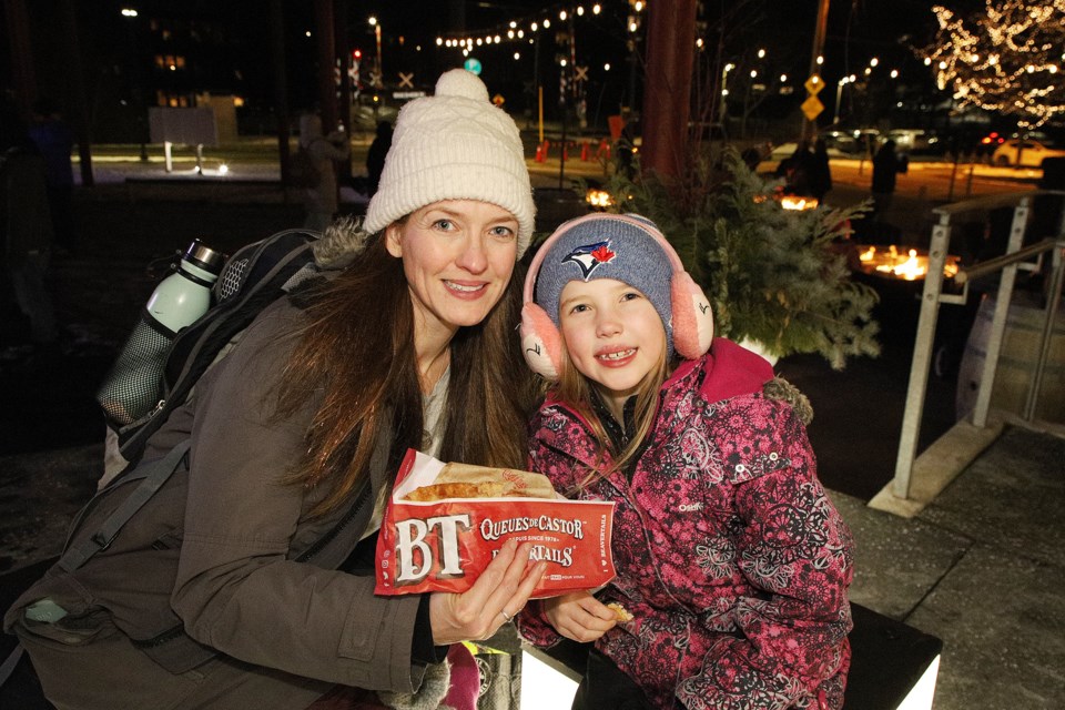 Laura Onofrio's daughter Jolene celebrates the new year and her eighth birthday with a beaver tail at last night's new year's levee hosted by Newmarket Mayor John Taylor and council at Riverwalk Commons.