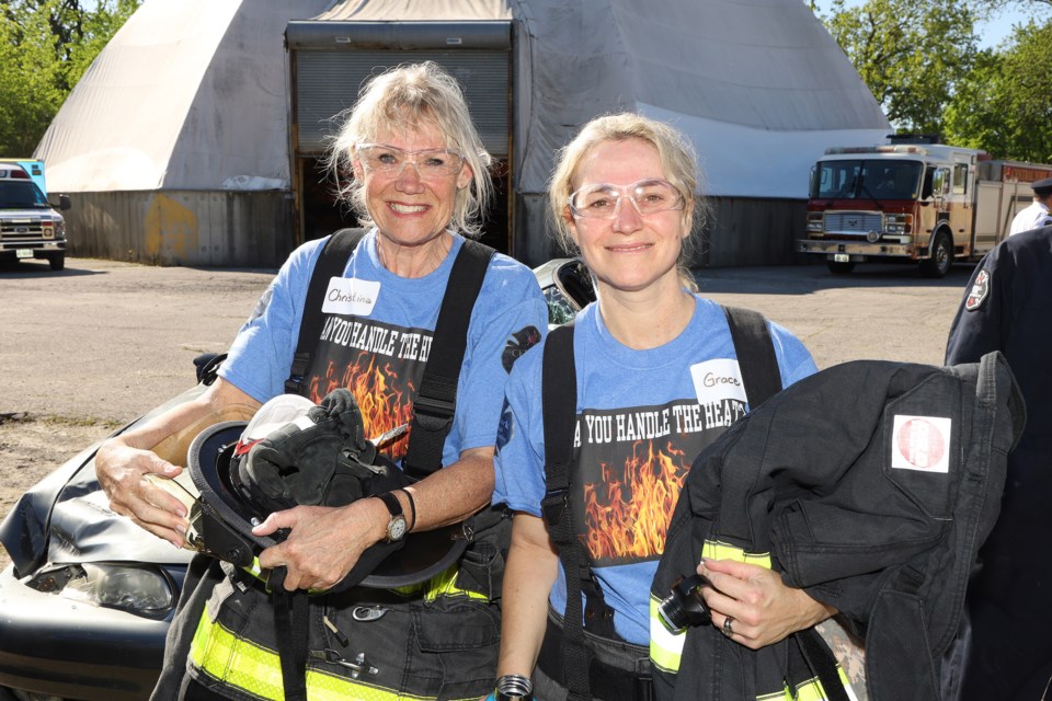 Newmarket councillors Christina Bisanz (left) and Grace Simon take a break from their firefighting duties at Fire Ops 101 at the CYFS training centre this morning.  Greg King for NewmarketToday