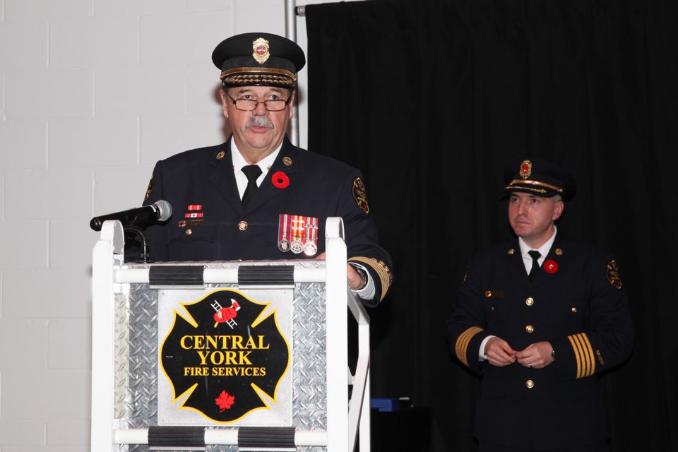 CYFS Fire Chief Ian Laing gives his remarks with MC Deputy Fire Chief Rocco Volpe in the background.  Greg King for Newmarket Today