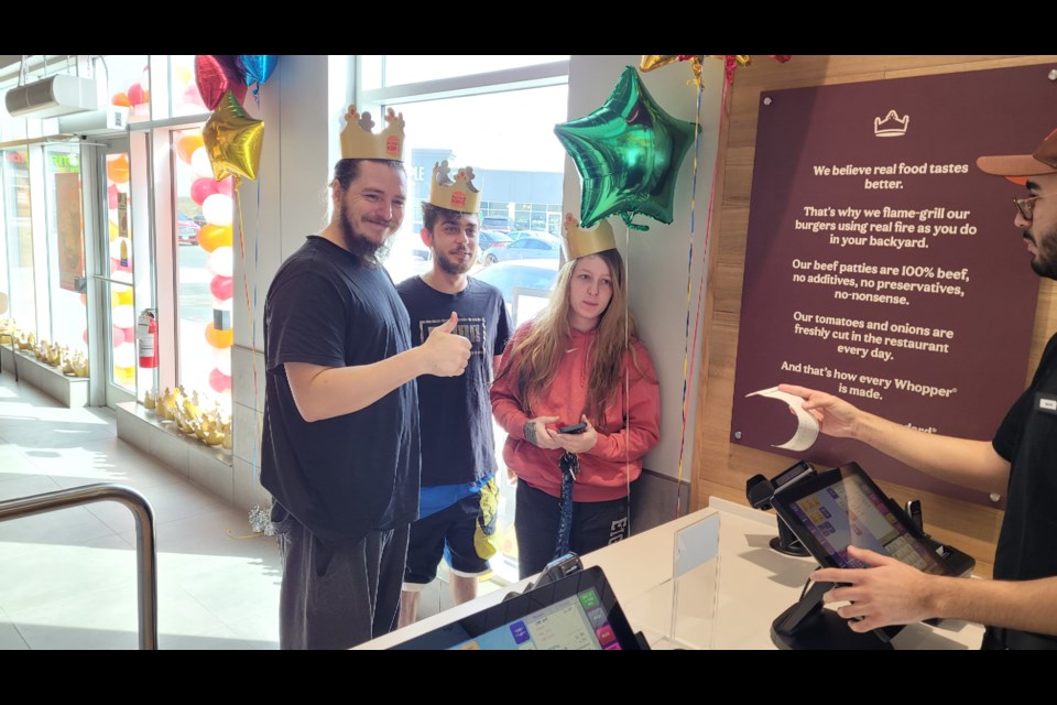 Ken (from left), Austin and Amber MacDonald place their orders as the first customers of the new Burger King in Newmarket. 