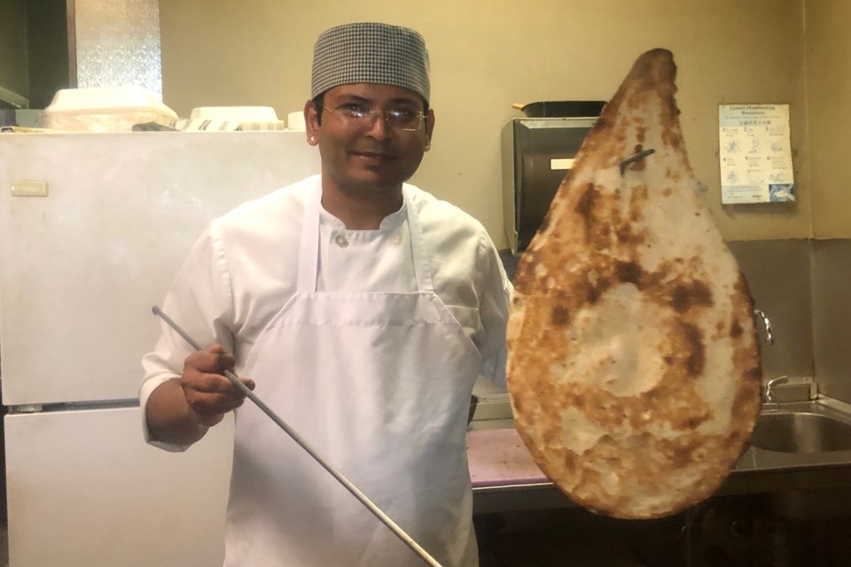 Chef Prabhat makes homemade naan at India Gate in Newmarket, which opened 18 years ago.