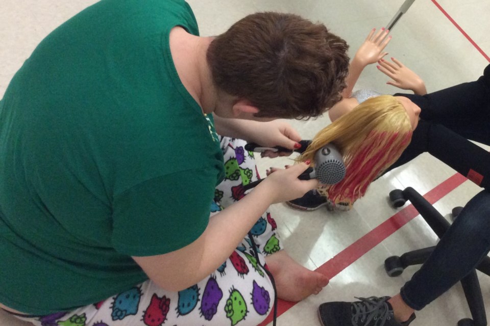 Tiffany, 17, is shown here practising cosmetology skills at school in December 2019. Supplied photo/Meagan Whitehorn