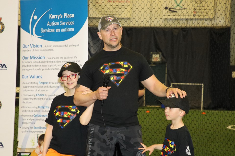 York Regional Police Const. Adam McEachern, with his sons, at the Newmarket Soccer Club before he begins his 12-hour challenge to raise awareness of autism, and support for Kerry's Place and Special Olympics. Greg King for NewmarketToday