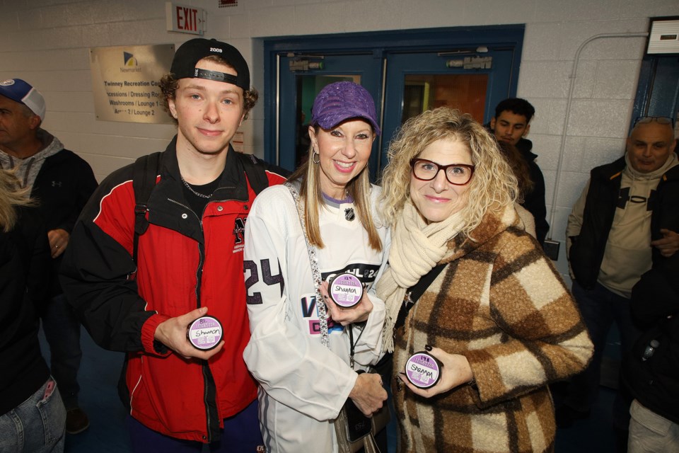 Tanner Kerr-Polgen, Shannon Kerr-Polgen, and Elyse Gladman have their pucks ready for the chuck-a-puck contest at the Newmarket U18AA Renegades' Hockey Fights Cancer fundraising event last night at Ray Twinney Recreation Complex.  The Renegades held the event during their game against the Upper York Admirals, with a bake sale and chuck-a-puck aiming to raise $2,000.