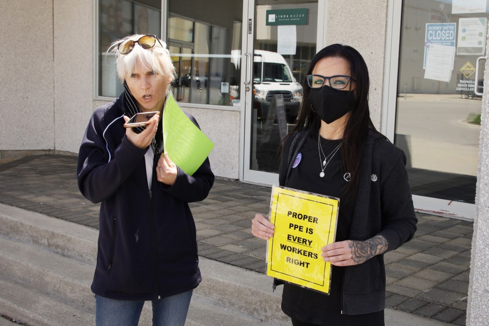 CUPE Local 905 president Katherine Grzejszczak and health-care worker and activist Rosie Buote, try to arrange a meeting with Health Minister Christine Elliott during a June 12 protest at the MPP's constituency office.  Greg King for NewmarketToday