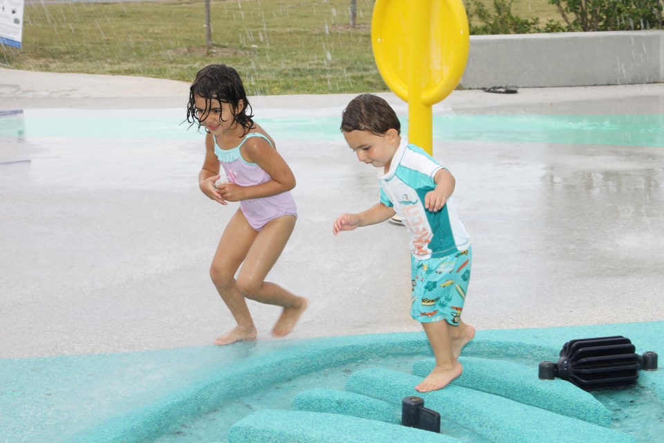 Valentino and sister Sofia play in the splash pad.  Greg King for NewmarketToday