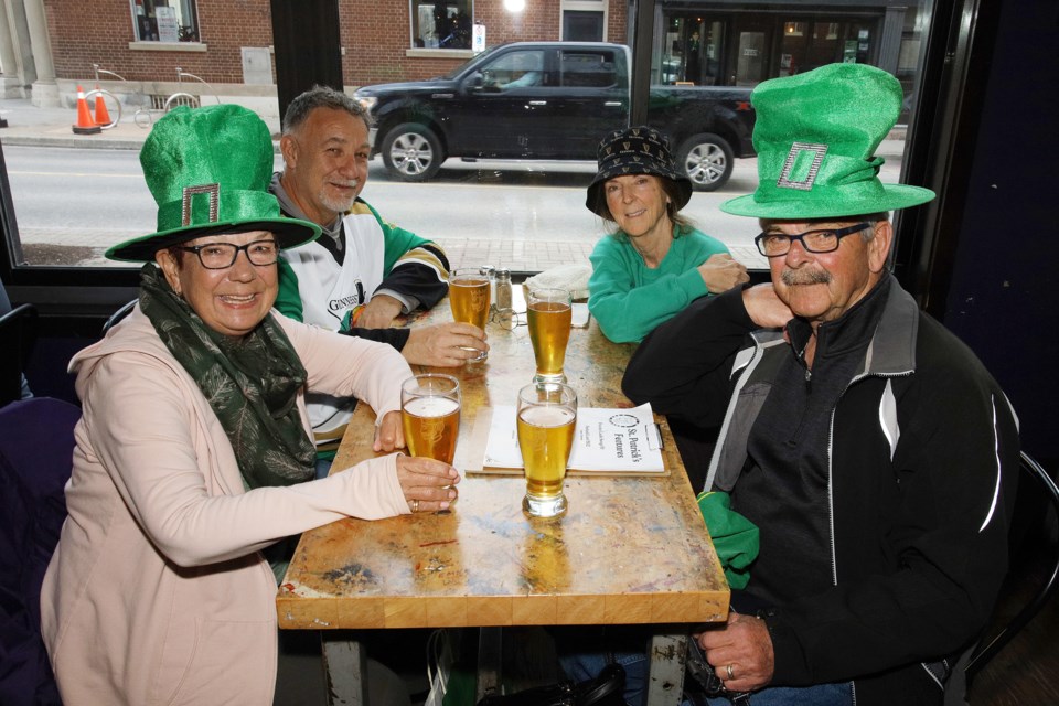 Louise Mackie, Marcel Chaisson, Nancy Chaisson, and Bob Murphy celebrate with a pint at The George.