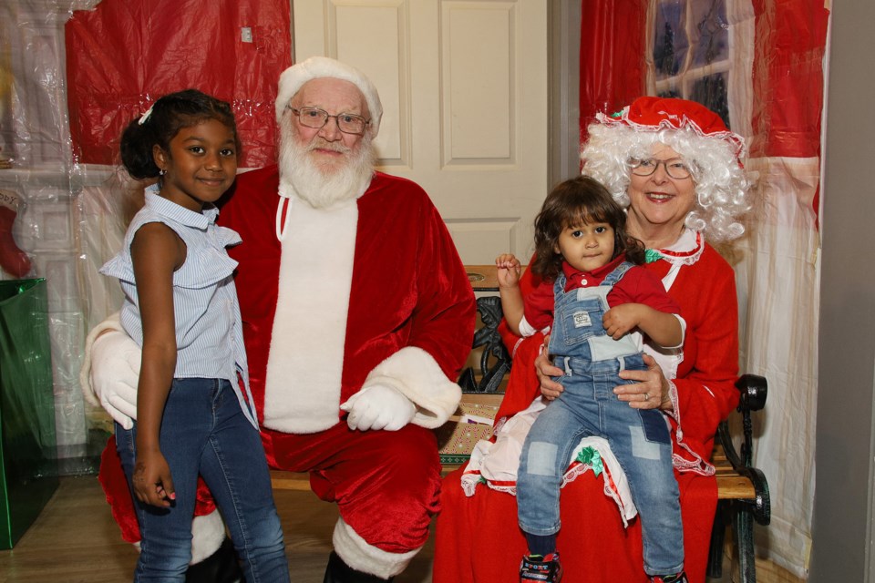 Tallin and Moday Mirghani share wish lists with Santa and Mrs. Claus Santa and Mrs. at Breakfast with Santa hosted by the Newmarket Optimists Saturday, Nov. 30.  Greg King for NewmarketToday