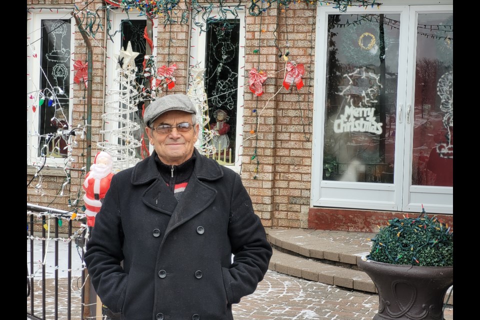 Luis Reis in front of his house on Billings Crescent, which he decorates for Christmas every year. 