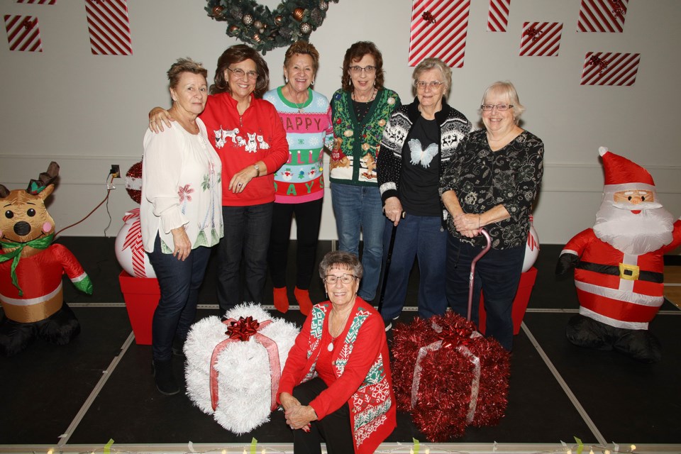 Out came the Christmas sweaters for the annual Seniors’ Christmas Social Tea Sunday with music, refreshments, prizes and friends at Newmarket Seniors’ Meeting Place. Here are  Sally Campisi, Angie Winder, Marieka Lee, Elizabeth Nicholas, Sue Andrews, and Carol Weaver with Carol E. sitting down.