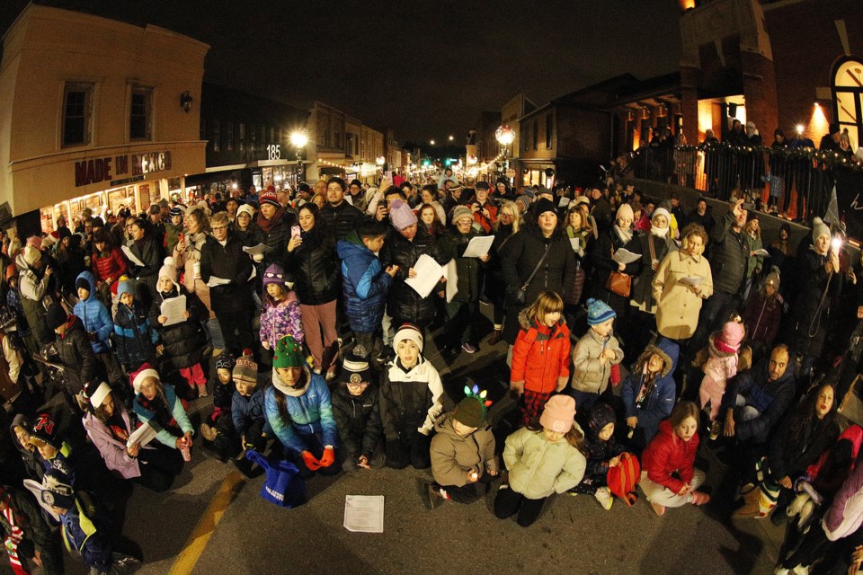 Hundreds of people gathered to sing Christmas carols on Main Street Newmarket for the candlelight parade and tree lighting.