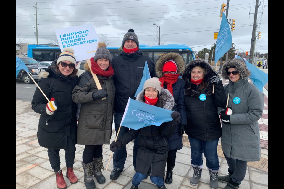 Newmarket's Sacred Heart Catholic High School teachers Kyla King (from left), Sarah Ladouceur, Jason Scott, Stephanie Leung, Gina Salib, Melissa Hayden and Tanja Hartmann were on the picket line at Yonge Street and Davis Drive for today's one-day OECTA strike. Debora Kelly/NewmarketToday