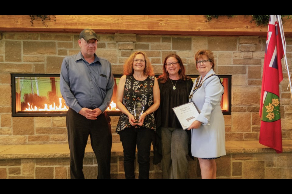 Former Georgina councillor Stephen Pallett, who died in March, was named the town's Citizen of the Year during the Volunteer Award of Merit ceremony Thursday at the ROC. Members of his family were on hand to accept the award from Mayor Margaret Quirk, right.