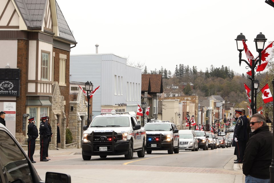 Members of York Regional Police line up on both sides of Main Street to pay their last respects to Sgt. Gerry Kempers.  Greg King for NewmarketToday