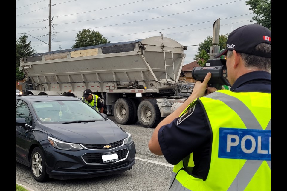 York Regional Police Sgt. Reid monitors the speed limit, while Const. DeRoy speaks to a driver who was pulled over on Bathurst Street during Operation A.B.C. in Newmarket. 