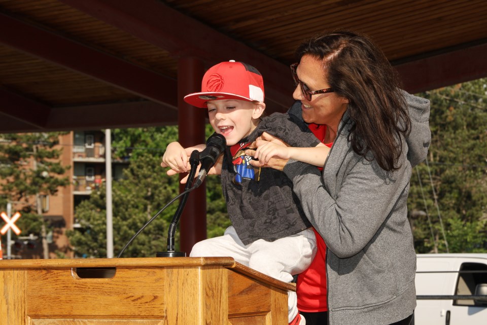 Sonja Plunkett holds her grandson, Robinson, at the Race for Plunkett and Law Enforcement Torch Run June 14 in Newmarket.  Greg King for NewmarketToday