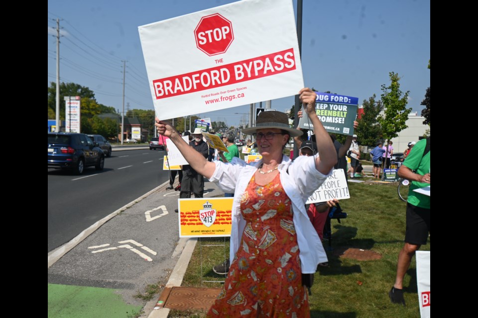 Diana Lumsden holds a sign during Saturday’s rally.