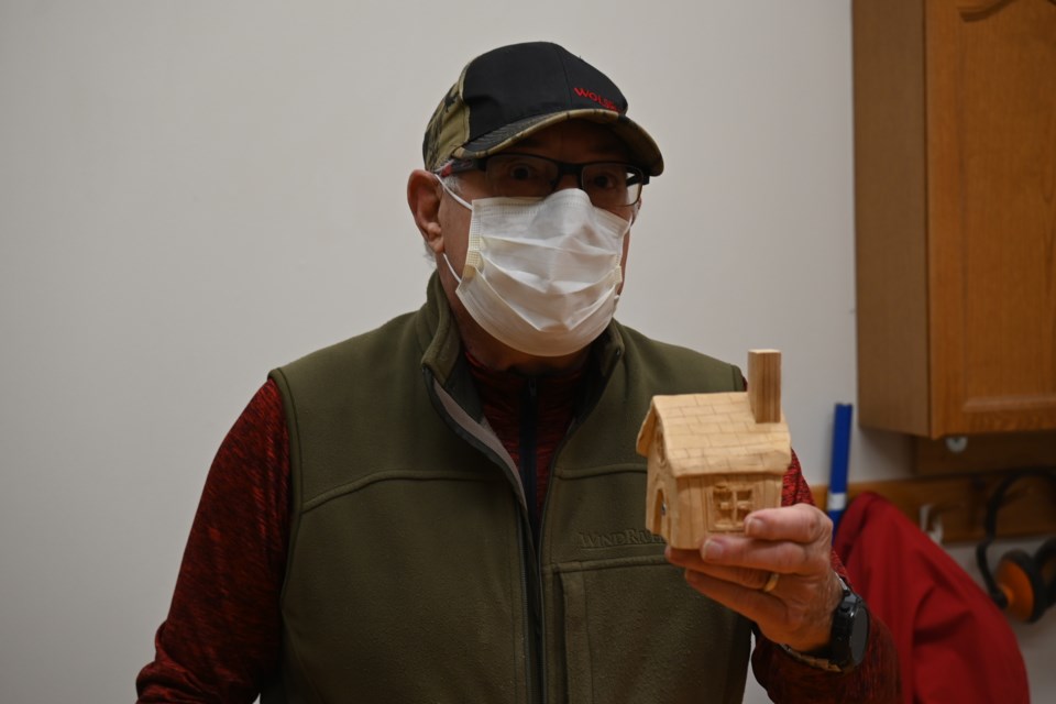 Don Zecchino holds up a carving he made at the Newmarket Seniors' Meeting Place, which reopened Nov. 15. 