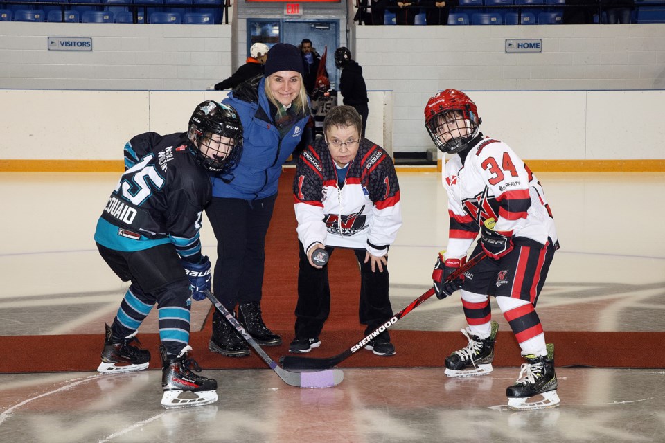 Newmarket Councillor Grace Simon and Newmarket Minor Hockey Association president Lynda Carusi drop the ceremonial puck at the event marking the Renegades U9MD White and Red teams' move to full ice Saturday, Jan. 20 at Ray Twinney Recreation Complex.