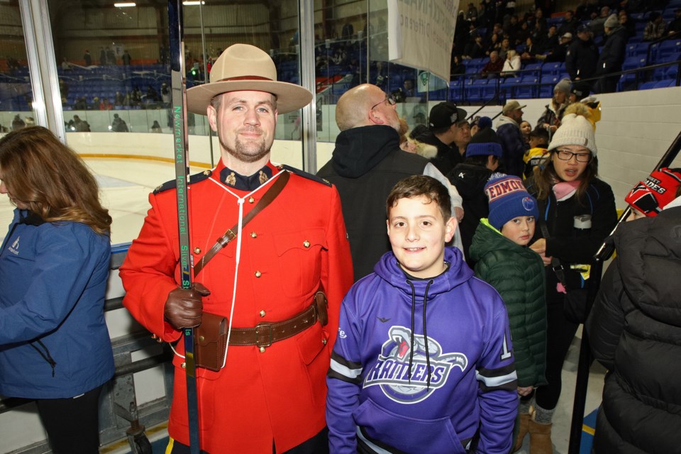 Gino Baratts of the Rochester Rattlers poses for a photograph with 
RCMP Const. Adams and the Silver Stick at the 38th International Silver Stick Tournament hosted by Newmarket, with 80 teams from across North America playing in Newmarket and Aurora this weekend.