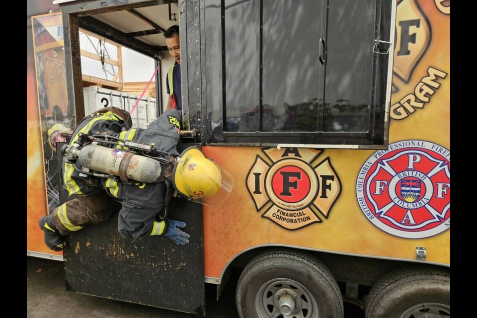 Fancy moves: A New Westminster firefighter demonstrates moves that would make Spiderman proud, while going through ground survival training. photo New Westminster Fire and Rescue Services 