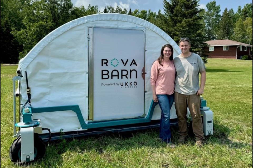 Chelsea and Zach Manners standing in front of Northern Ontario's first fully automated poultry barn on delivery day.