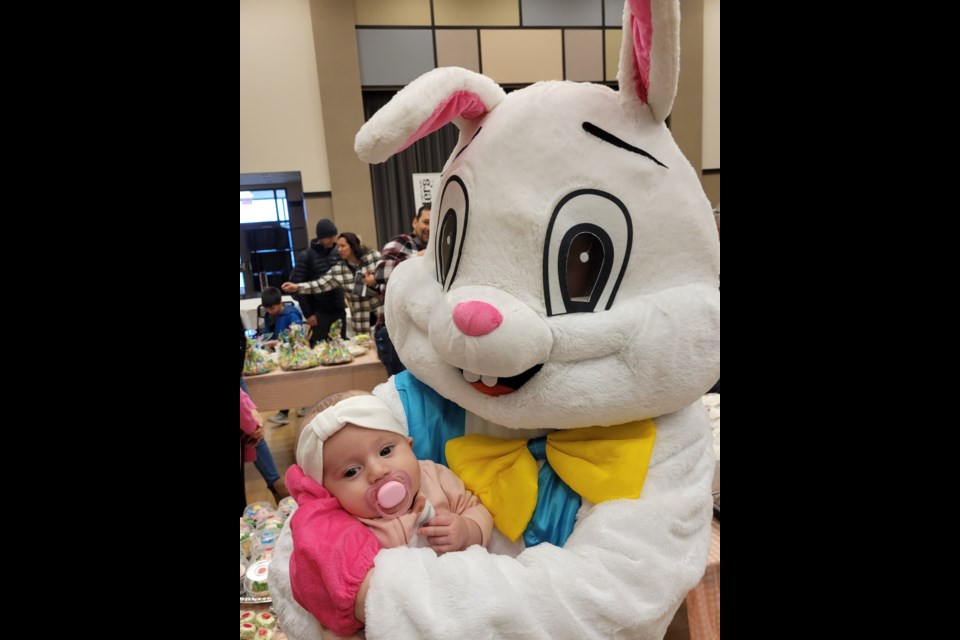 Eggs the Bunny gives baby Tenaya Turner a cuddle at the Niagara Nursery School Bunny Trail in NOTL Saturday.