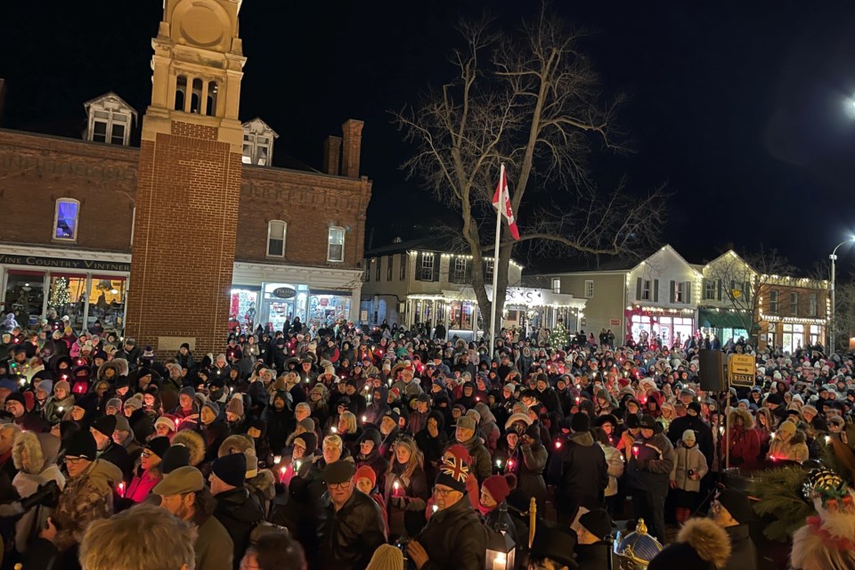 The crowd gathered by the steps of the Court House Friday evening waits for the Candlelight Stroll, organized by the Niagara-on-the-Lake Chamber of Commerce, to begin. 