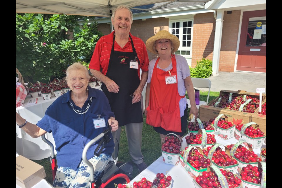 There will be lots of fresh cherries for sale, but much missed this year will be Judy MacLachlan, who was always a the table, last year with  Gary Burroughs and Barbara O'Connor. MacLachlan passed away last October.