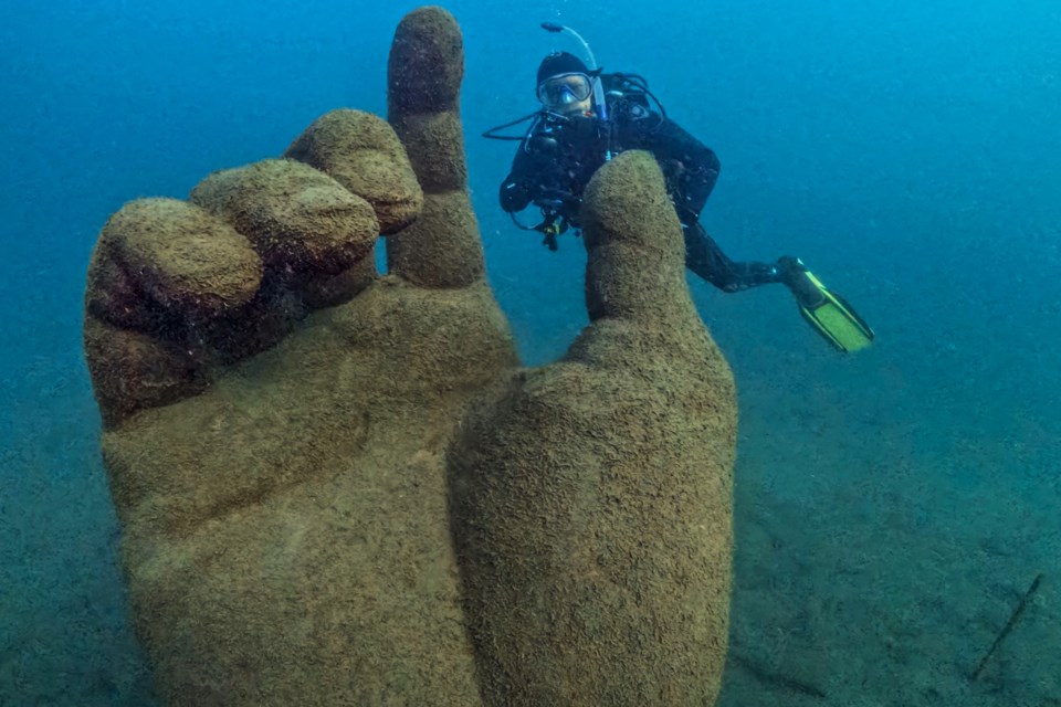 Ascension, one of the statues at Centeen Memorial Park, with diver Jimmy Lockard.