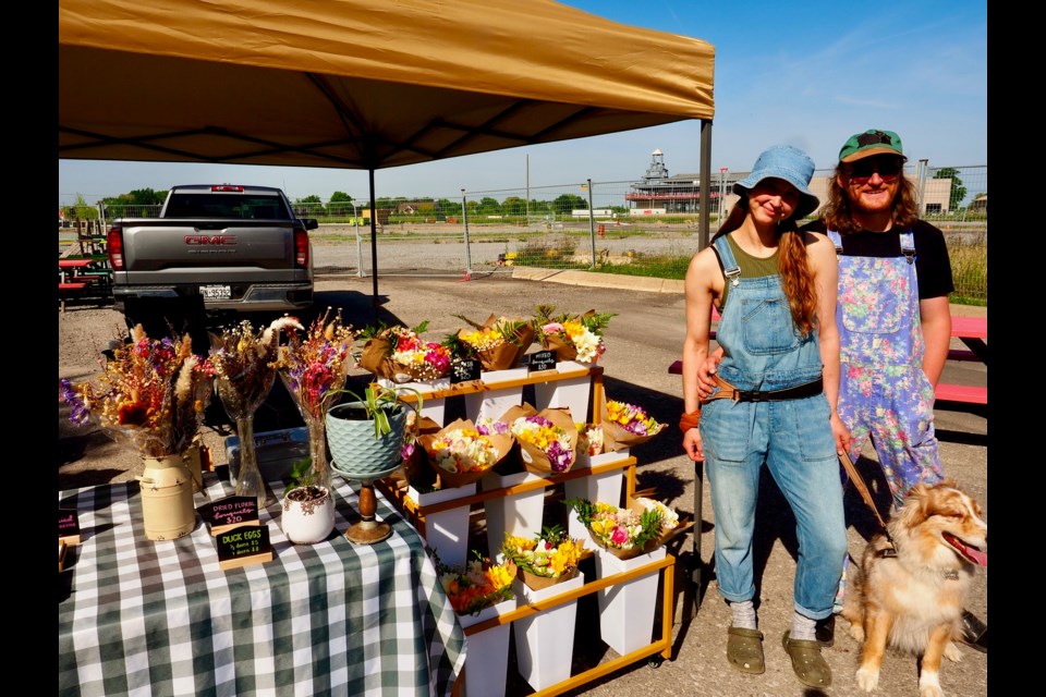 Carter Snow and Erin Rolanty of LowKey Farmstead with their dog LowKey at the Farmers' Market.