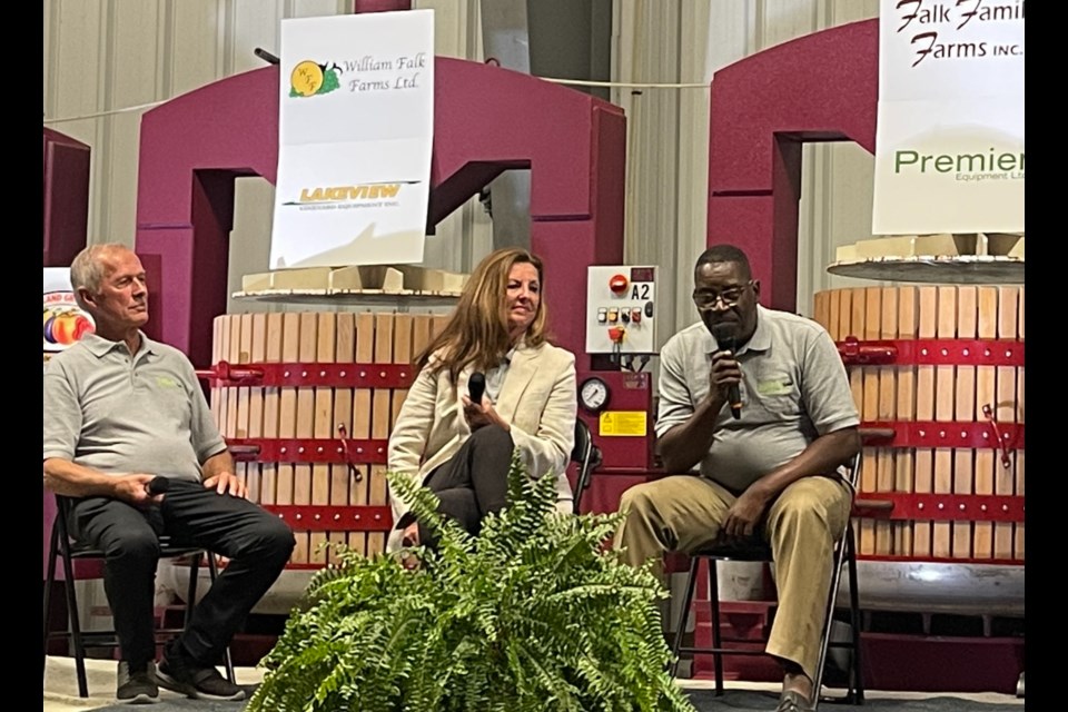 Bill Falk, Betsy Wall and Bapthol Joseph talking about Haiti.