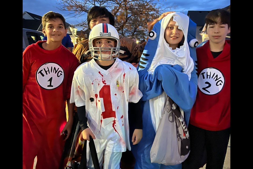 A group of friends trick or treat together in Virgil.