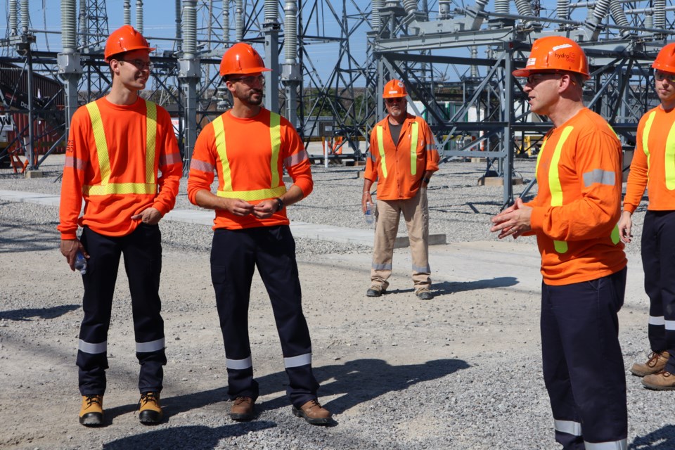 Andrew Spencer of Hydro One explains how the circuit breakers work to Niagara West MPP Sam Oosterhoff and Energy Minister Stephen Lecce during a tour of the Beck #2 Transformer Station. 