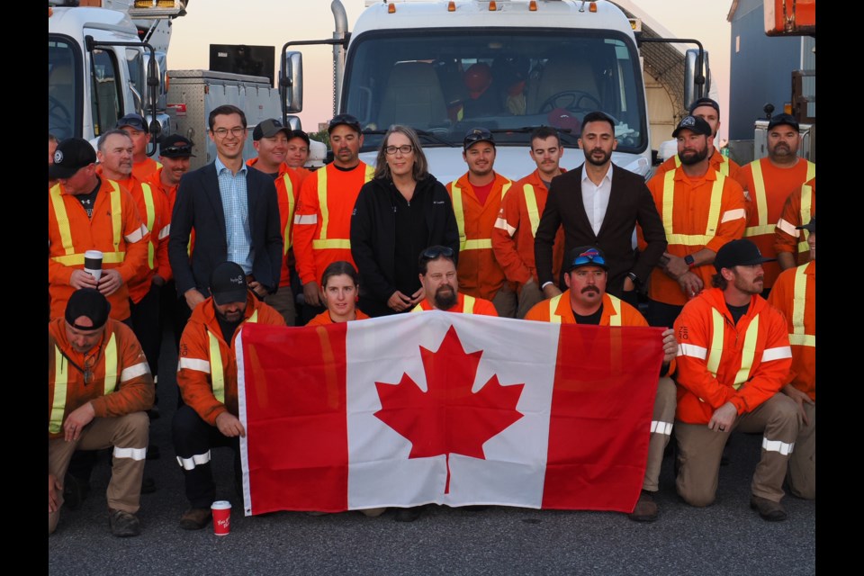 MPP Sam Oosterhoff, Hydro One's Teri French and Stephen Lecce, provincial minister of energy and electrification, at the Husky Travel Centre with some of the crew members heading to Georgia.