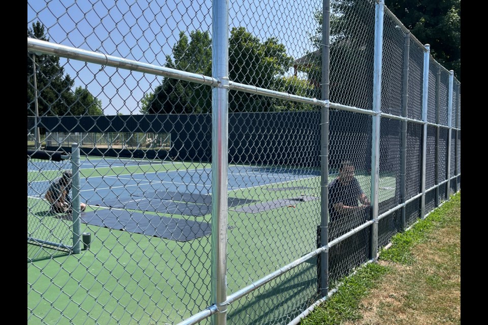 Town parks and recreation staff were installing sound barriers at the outdoor courts in Virgil on Wednesday.