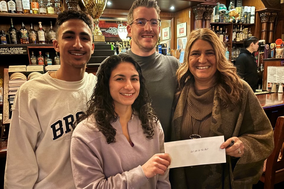 Zubin Gatta, Farrantina Gatta, Colin Wilson and Jovie Joki as she presents a cheque for the Gatta Get 'Em on the Mat fund at the Irish Harp.