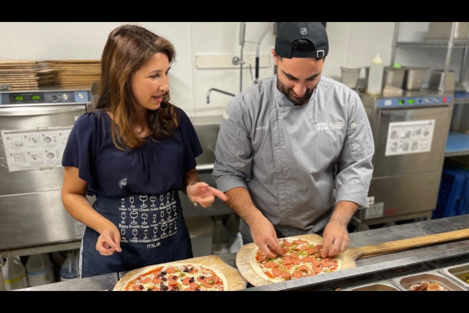 Topping pizzas and discussing Feast ON - putting Ontario first when sourcing ingredients and other inputs.