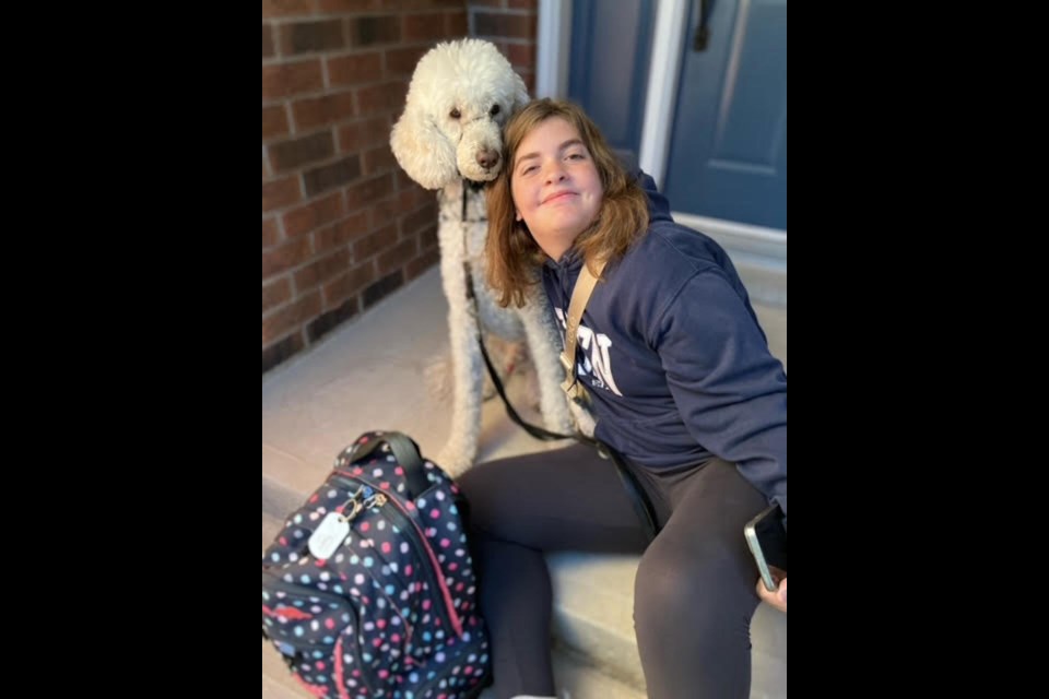 Megan Dyck, with her dog Teddy, waits for the bus to take her to Eden High School for her first day of Grade 10.