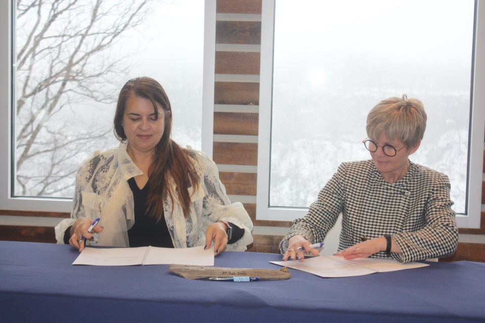  Caroline Lidstone-Jones, chief executive officer of the Indigenous Primary Health Care Council, signs an agreement with Niagara Health's chief executive officer and president Lynn Guerriero. 