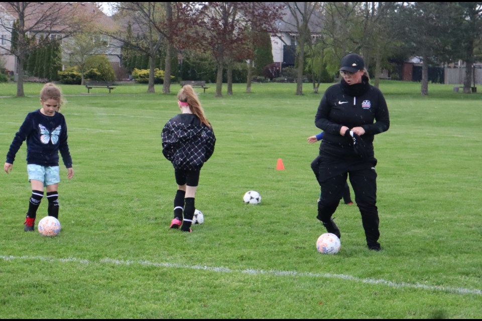 Brock Badgers women's soccer head coach Carli Tingstad working with members of the NOT Soccer Club's U8 girls travel team. 